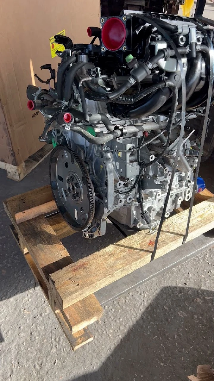 Engine on a wooden pallet, ready for installation.