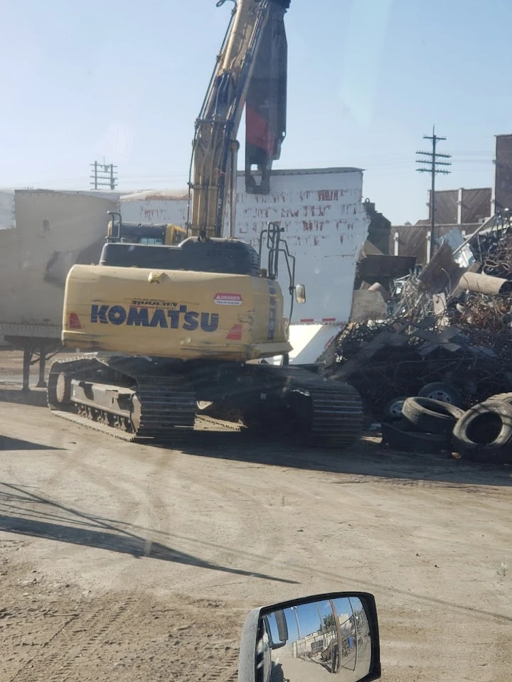 Excavator at a recycling facility with scrap metal.