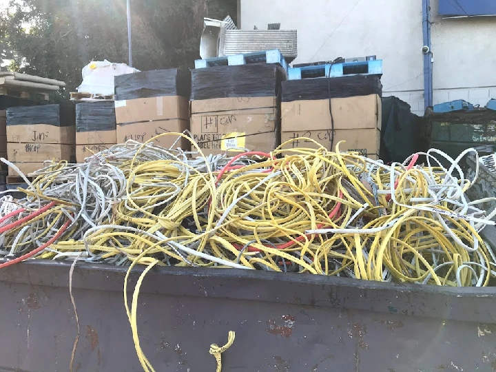 Heap of tangled wires in recycling container.