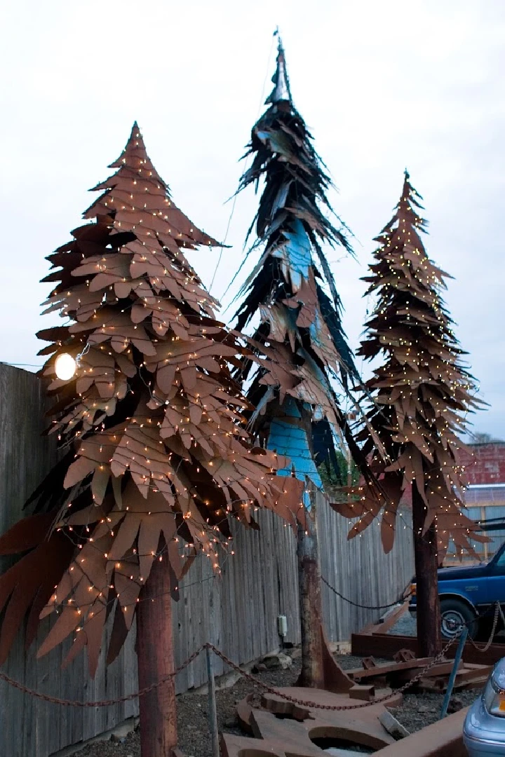 Metal trees decorated with lights at Burcham's Metals.