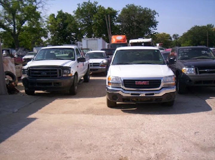 Parking lot with several used vehicles.