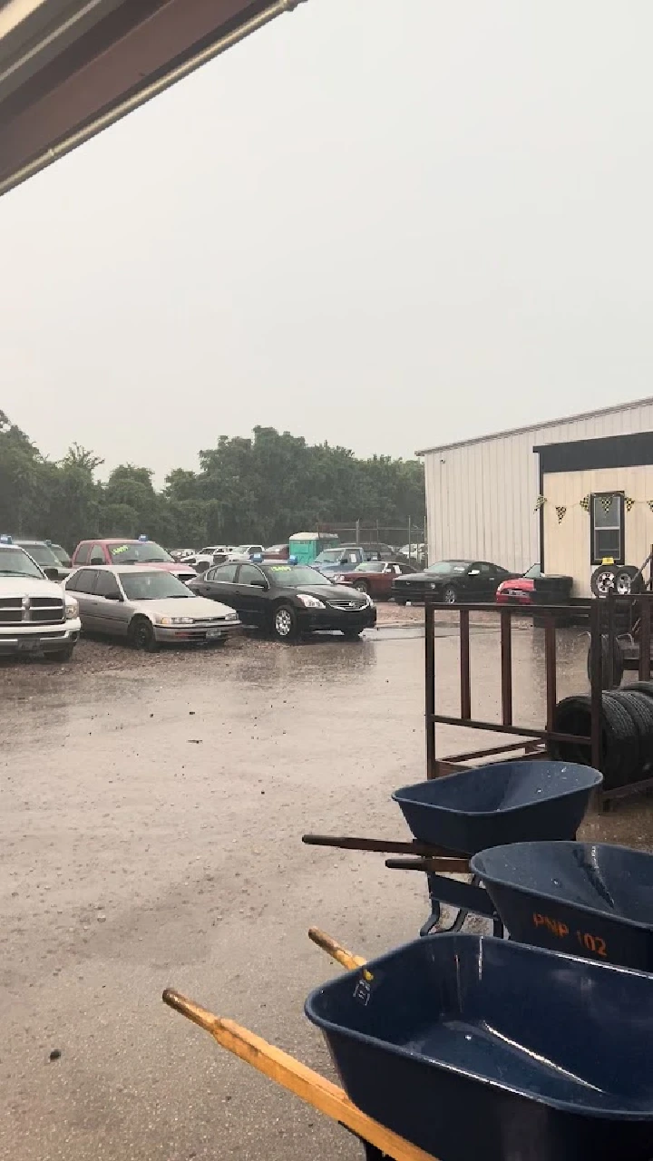 Pick-n-Pull lot with cars in rainy weather.