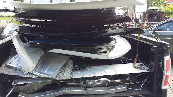 Stacked metal scraps in the back of a truck.