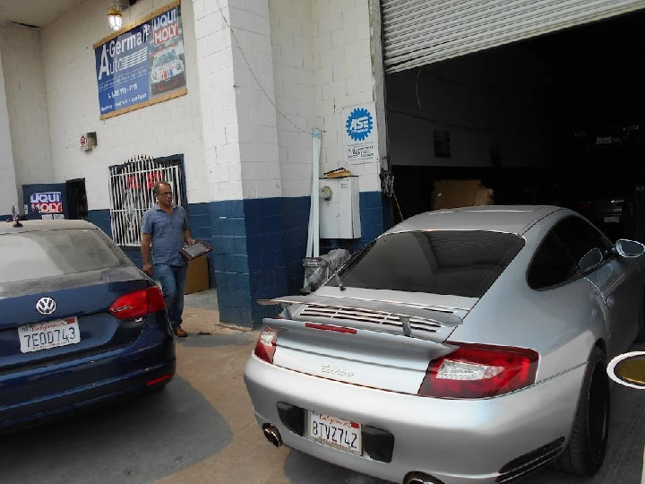 Two cars outside A-German Auto parts & service.