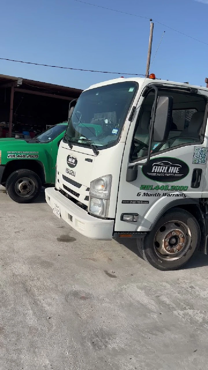 Two delivery trucks parked at Airline Auto Parts.