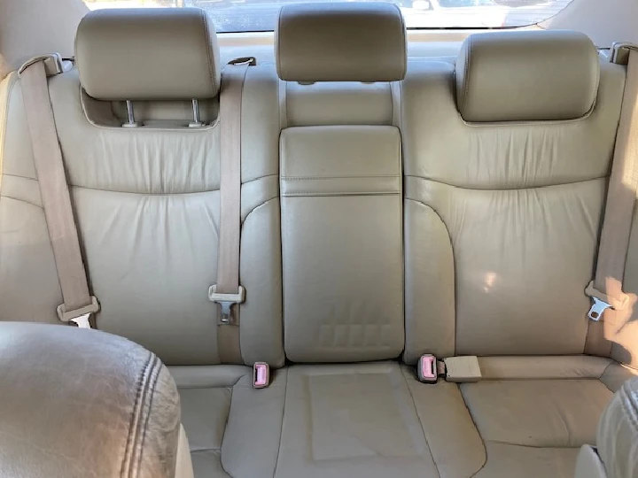 Used leather backseat interior of a vehicle.