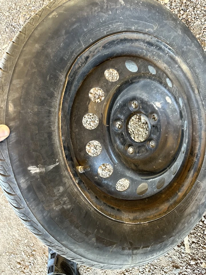 Used tire with rim at Payless Salvage Auto Parts.