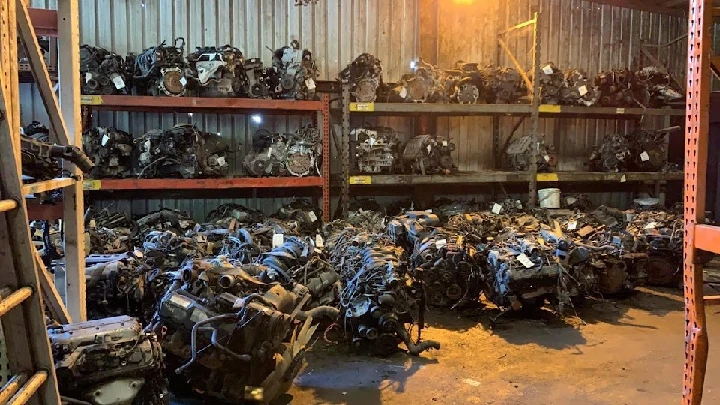 Warehouse filled with various auto engines and parts.