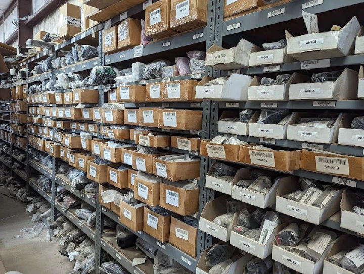 Warehouse shelves filled with electric vehicle parts.