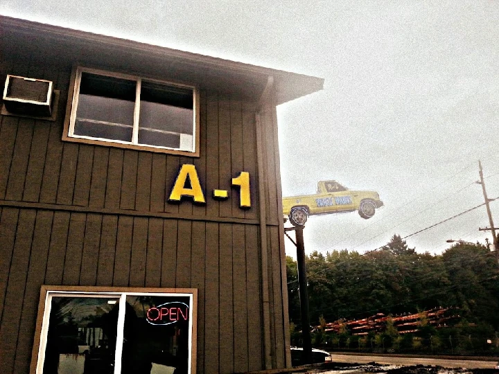 A-1 Light Truck Parts storefront with sign and truck.