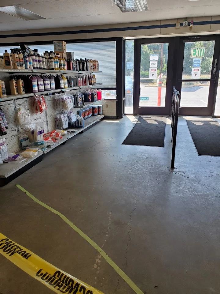 Auto parts store interior with shelves and exit.