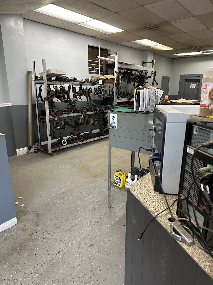 Auto recycling shop interior with parts and desk.