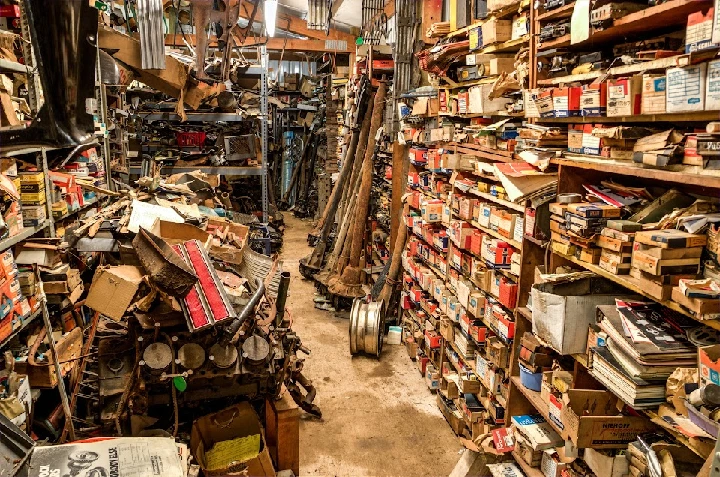 Cluttered interior of an old car parts shop.