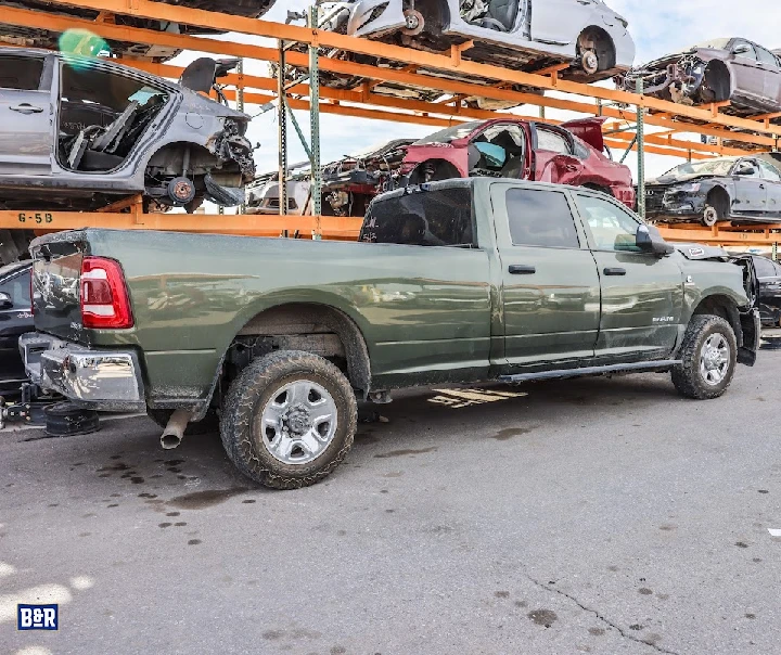 Green pickup truck at B&R Auto Wrecking yard.