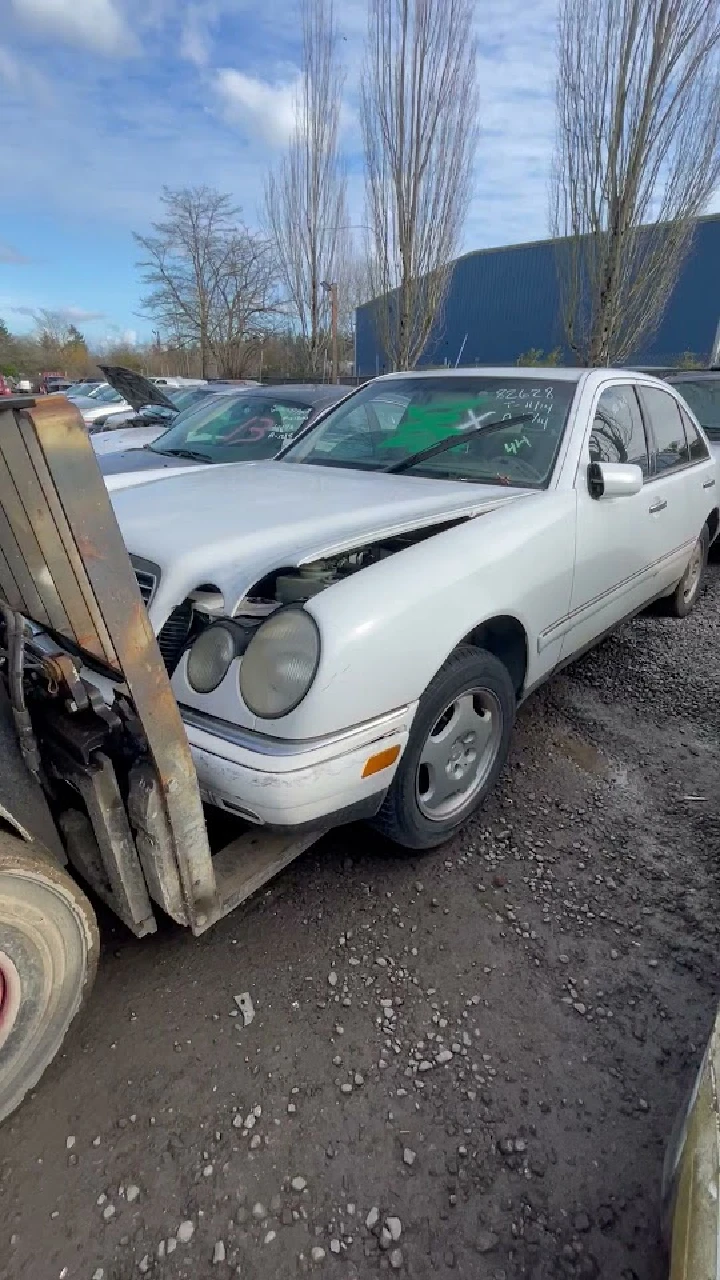 Junk car being lifted for disposal service.