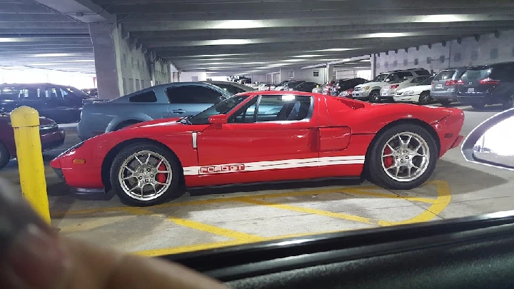 Red Ford GT parked in a garage.