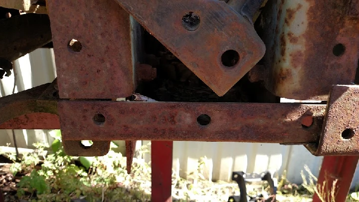 Rusty metal truck part at Miller Truck Salvage.