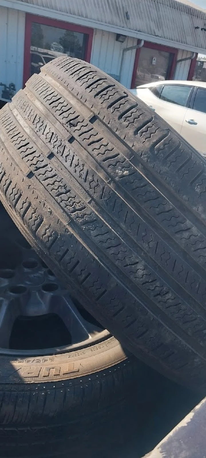 Stacked used tires at a scrap yard.