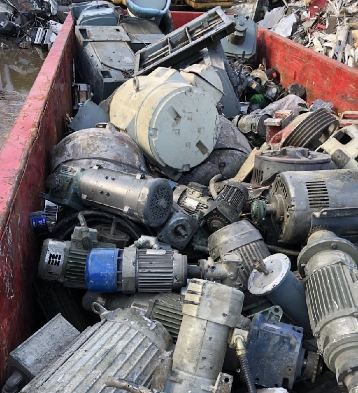 A pile of discarded industrial motors and machinery.