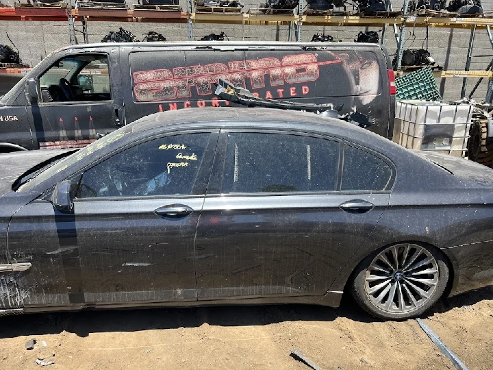 Abandoned car in a junkyard setting.