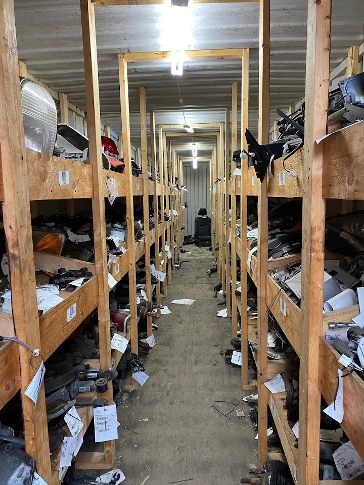 Aisle of shelves stocked with auto parts.