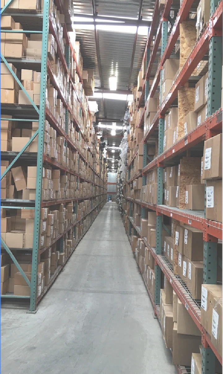 Aisle of stacked boxes in a recycling warehouse.