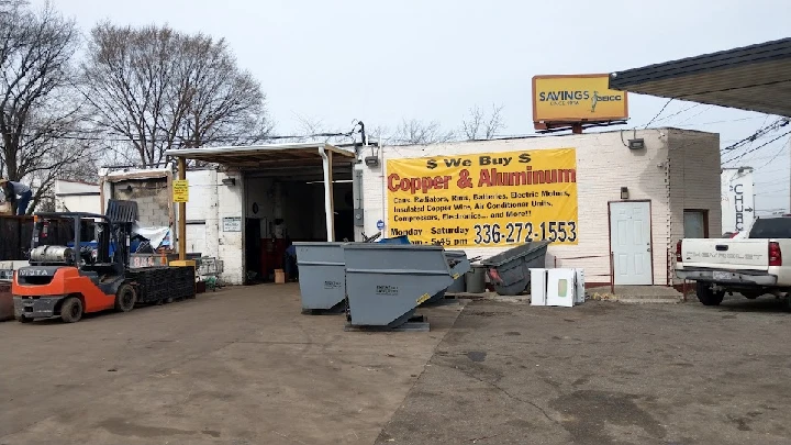 Aluminum recycling center with bins and signage.