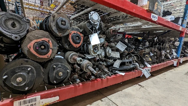 Assorted auto parts on a storage shelf.