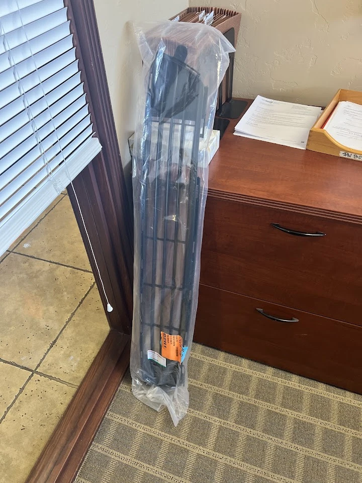 Auto body part packaged and placed in an office.