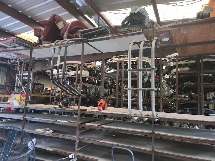 Auto parts displayed in an industrial wrecking yard.