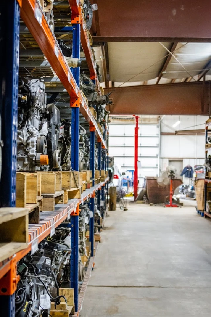 Auto parts displayed on shelves in a storage area.