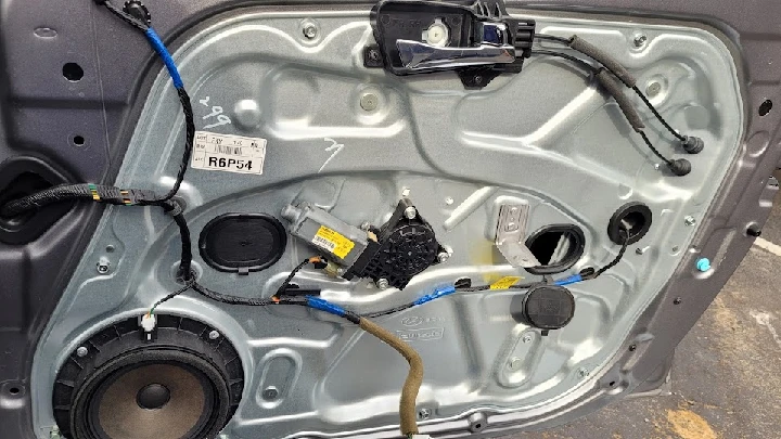 Auto parts: door panel with wiring and components.