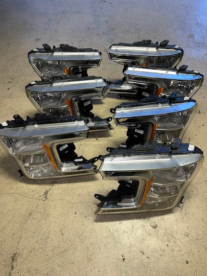 Auto parts: multiple vehicle headlights arranged.