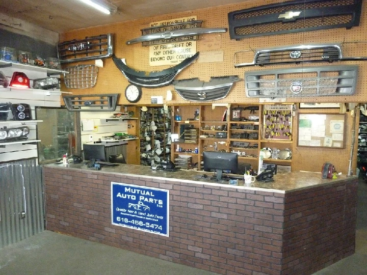 Auto parts shop counter with various car parts displayed.