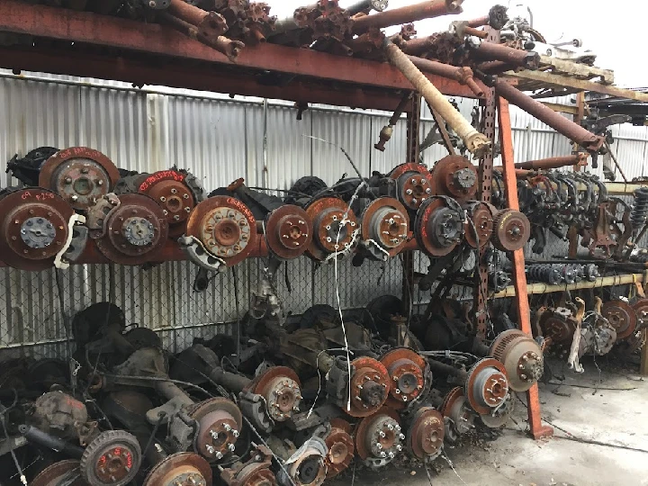 Auto parts stacked in a wrecking yard.