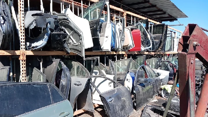 Auto parts storage with dismantled car doors.