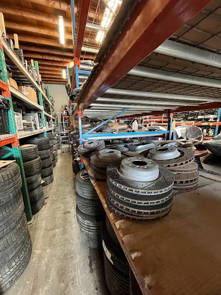 Auto parts and tires stacked in a storage area.