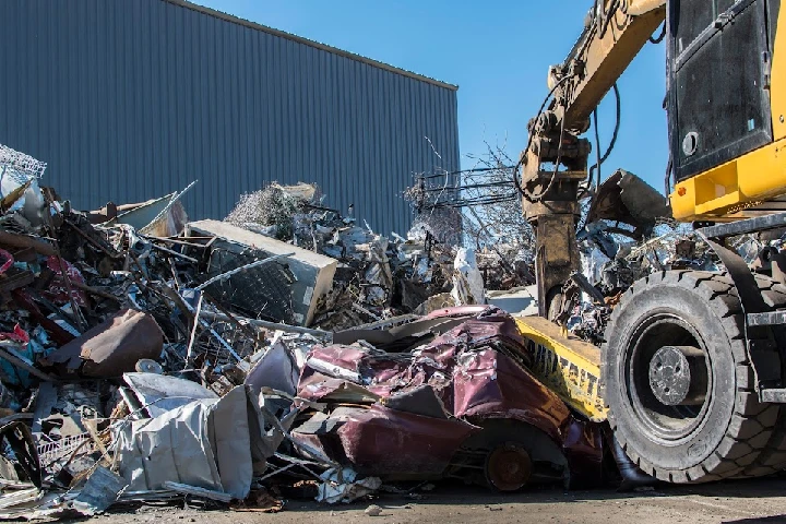 Auto recycling facility with heavy machinery and scrap.