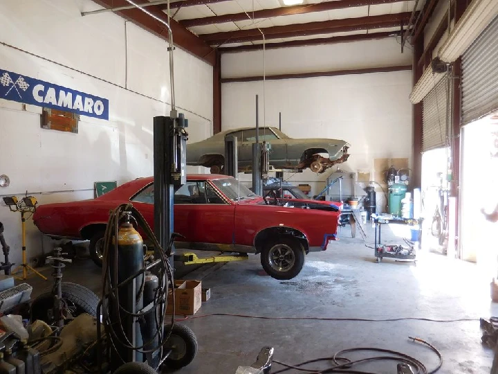 Auto repair shop with classic cars and equipment.