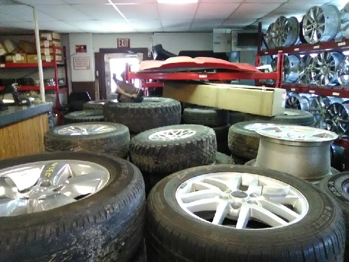 Auto salvage shop filled with tires and wheels.