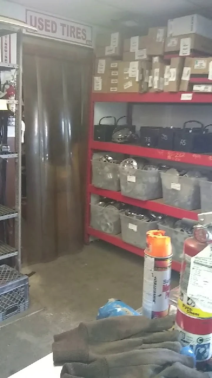 Auto salvage shop interior with shelves and items.