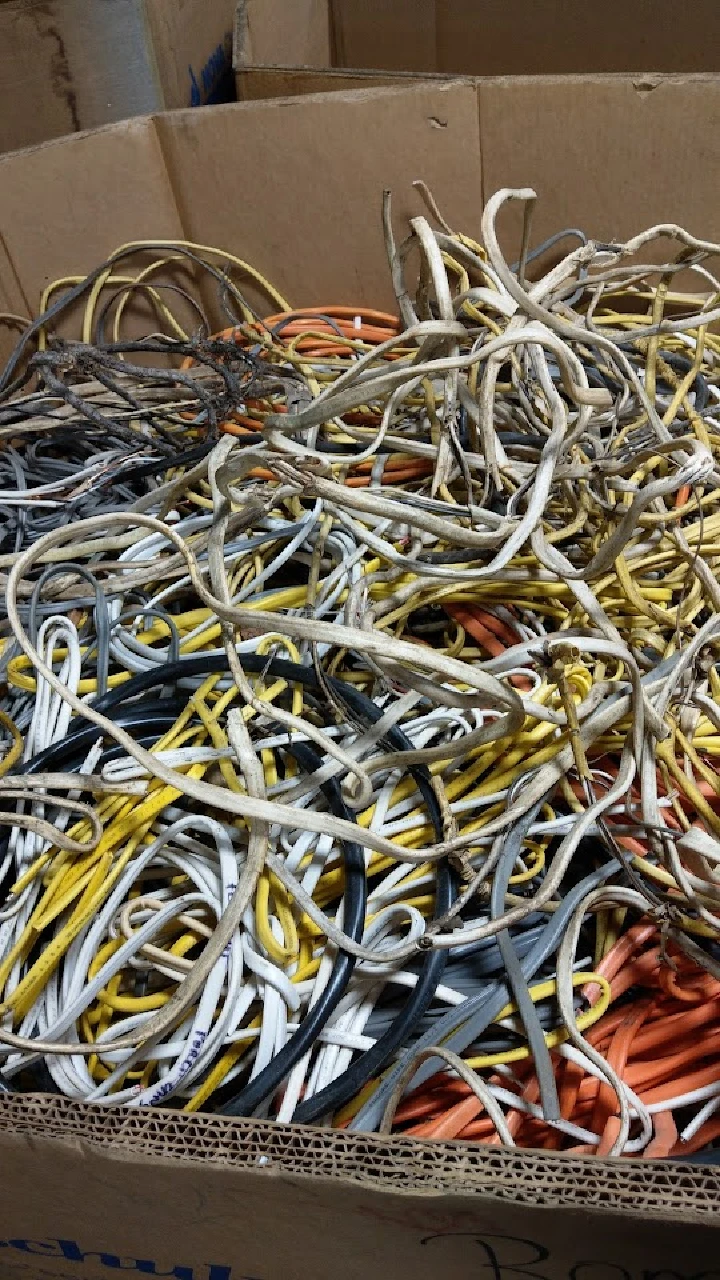 Box filled with tangled aluminum recycling wires.