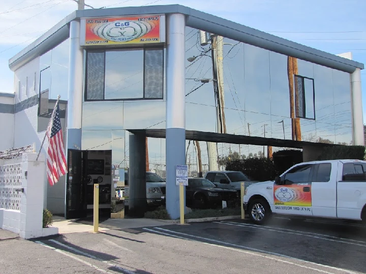 C&G Ford Parts building with American flag outside.