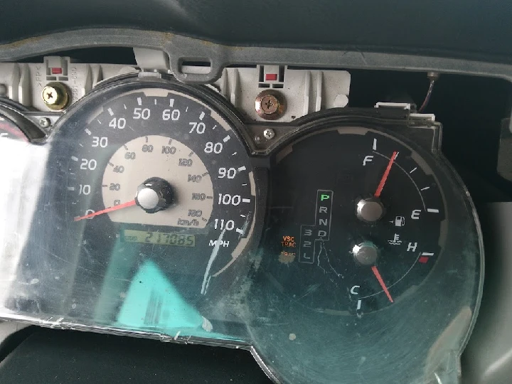 Car dashboard showing speedometer and fuel gauge.