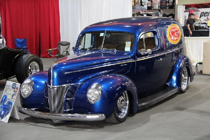 Classic blue vintage delivery truck at an exhibition.