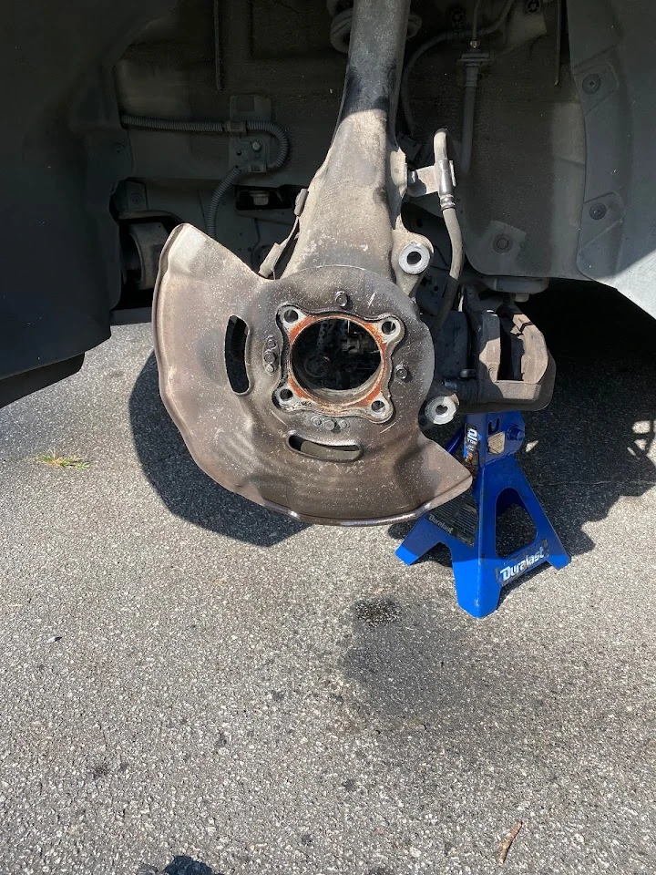 Close-up of car brake parts during maintenance.