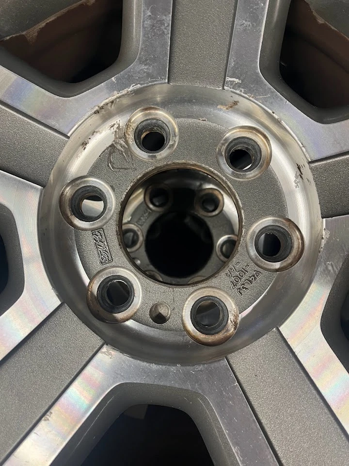 Close-up of a worn alloy wheel rim.