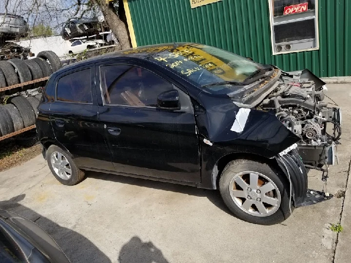 Damaged black car outside J & S Imported Auto Parts.