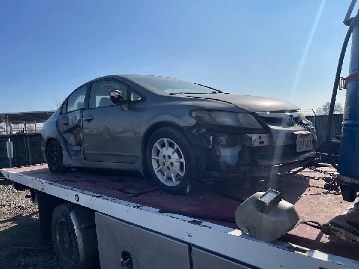 Damaged car loaded onto a tow truck.