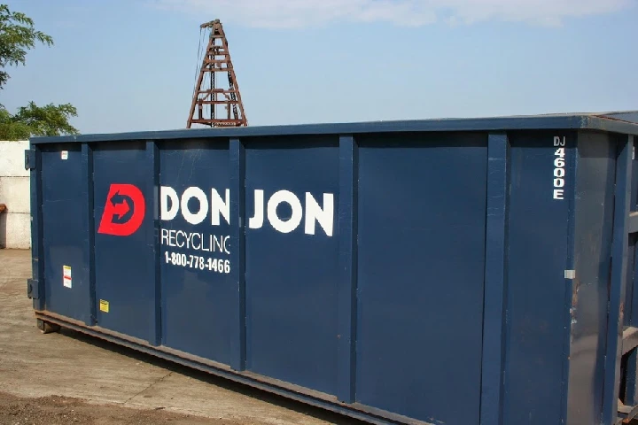 Don Jon Recycling dumpster on a work site.